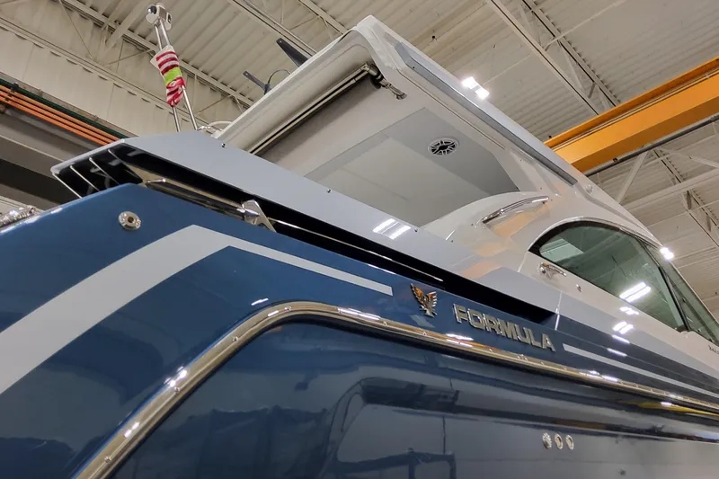  Yacht Photos Pics 2026 Formula 380 Super Sport Crossover OB boat in a showroom, showcasing sleek design.