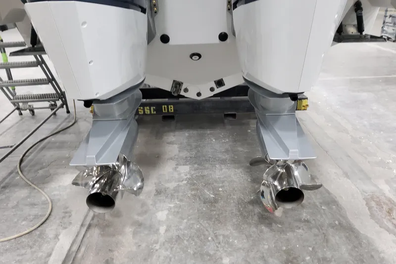  Yacht Photos Pics 2026 Formula 380 Super Sport Crossover OB outboard motors with dual propellers in a workshop.