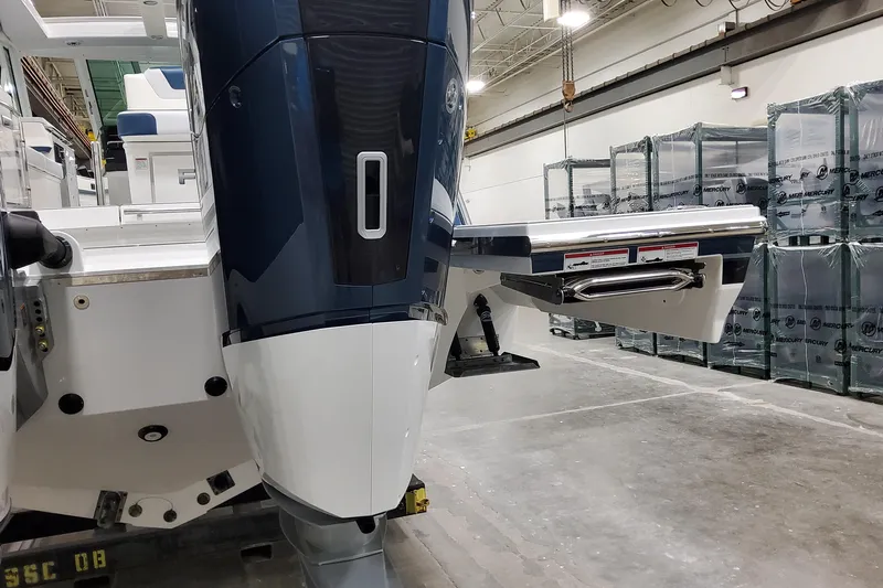  Yacht Photos Pics 2026 Formula 380 Super Sport Crossover OB boat engine in a warehouse setting.