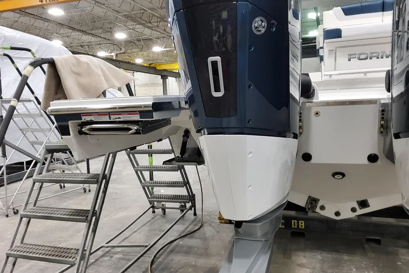  Yacht Photos Pics 2026 Formula 380 Super Sport Crossover OB in a workshop, showcasing outboard motors.