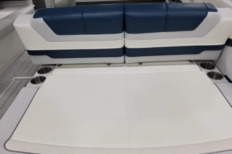  Yacht Photos Pics 2026 Formula 380 Super Sport Crossover OB interior seating with cup holders, featuring blue and white upholstery.