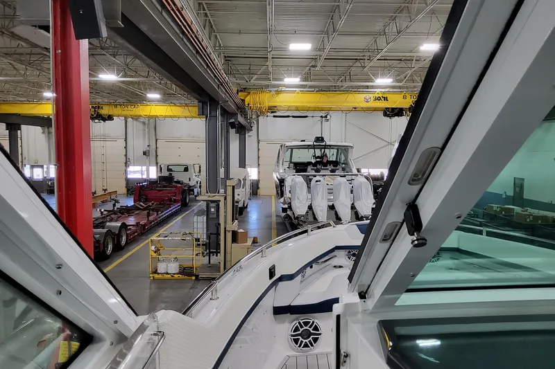  Yacht Photos Pics 2026 Formula 380 Super Sport Crossover OB in a factory setting with cranes and equipment.