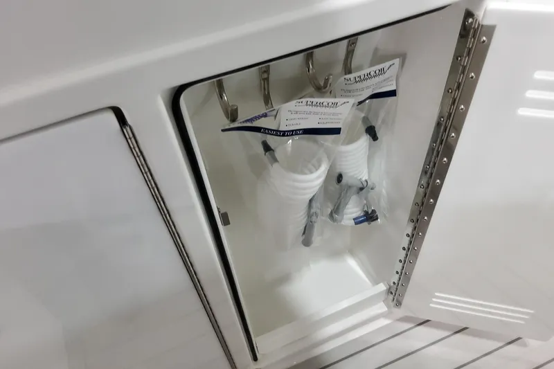  Yacht Photos Pics Storage compartment on 2026 Formula 380 Super Sport Crossover OB boat with coiled hoses.