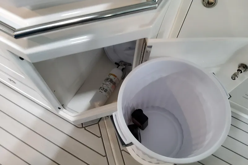  Yacht Photos Pics Open storage compartment on 2026 Formula 380 Super Sport Crossover OB boat, featuring a fire extinguisher.