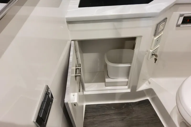  Yacht Photos Pics 2026 Formula 380 Super Sport Crossover OB interior with open cabinet and waste bin.