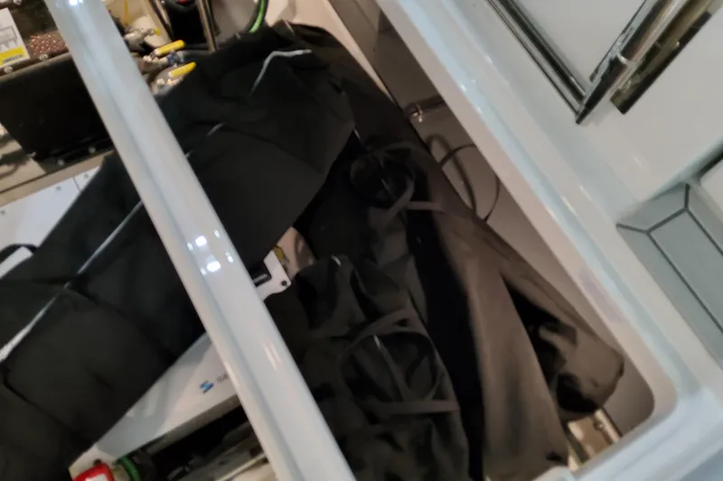 Yacht Photos Pics Storage compartment of 2026 Formula 380 Super Sport Crossover OB boat, featuring black bags.