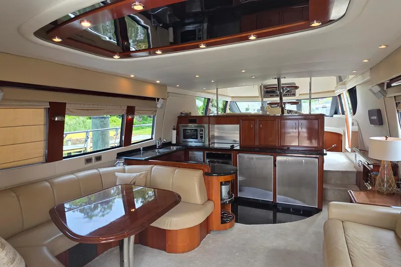 Mardi Gras Yacht Photos Pics Luxurious interior of a 2006 Carver 56 Voyager yacht with modern kitchen and seating area.