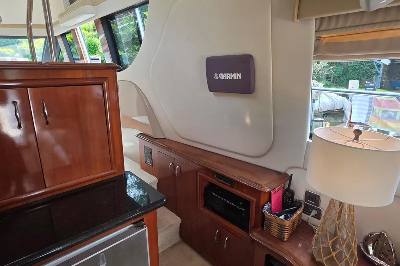 Mardi Gras Yacht Photos Pics Interior of 2006 Carver 56 Voyager yacht with Garmin navigation system and elegant wood cabinetry.