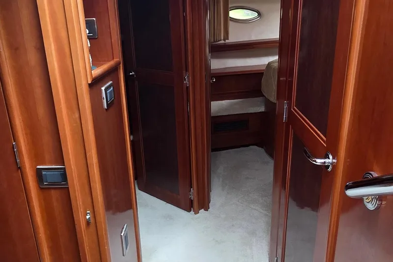 Mardi Gras Yacht Photos Pics Interior of 2006 Carver 56 Voyager yacht, featuring polished wood doors and cozy cabin space.