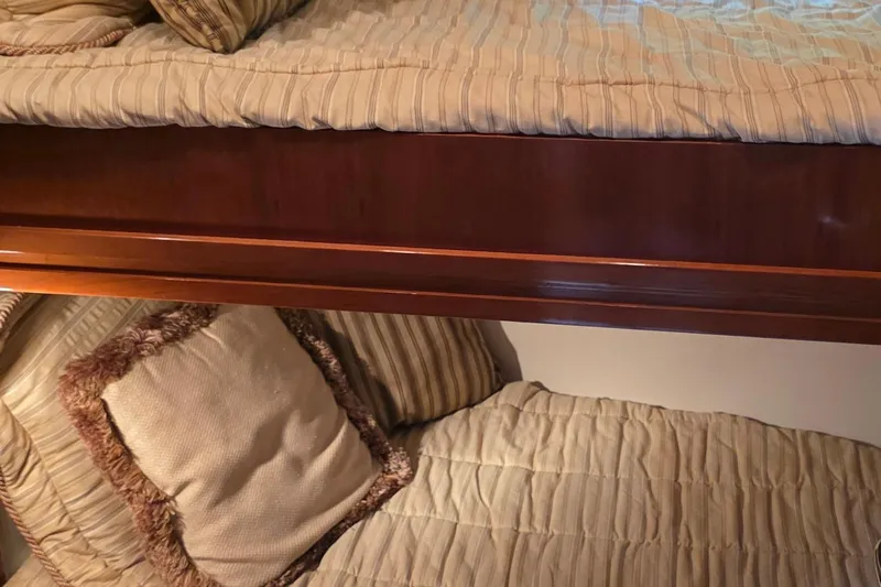 Mardi Gras Yacht Photos Pics Interior of 2006 Carver 56 Voyager with cozy bunk beds and striped bedding.