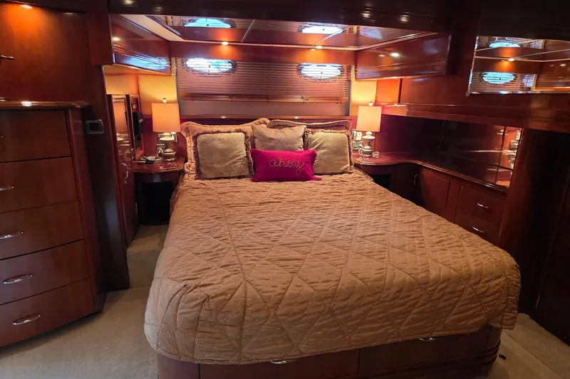 Mardi Gras Yacht Photos Pics Luxurious bedroom interior of 2006 Carver 56 Voyager yacht with elegant wood finishes.