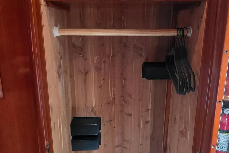 Mardi Gras Yacht Photos Pics Wooden closet interior with hangers in a 2006 Carver 56 Voyager yacht.