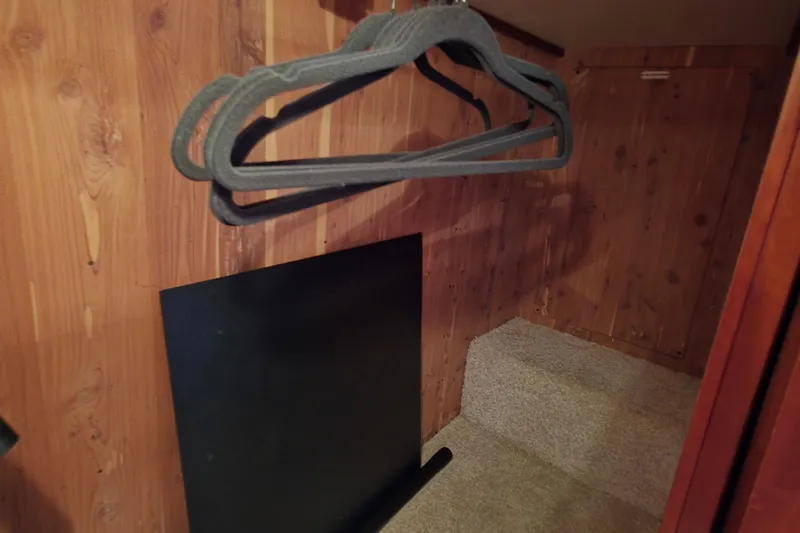 Mardi Gras Yacht Photos Pics Wooden closet interior with hangers, inside a 2006 Carver 56 Voyager yacht.