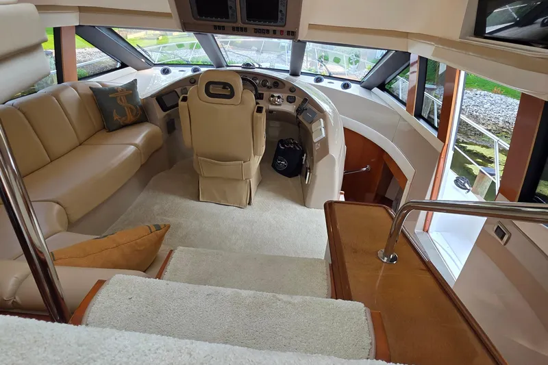 Mardi Gras Yacht Photos Pics Luxurious interior of 2006 Carver 56 Voyager yacht with plush seating and helm.