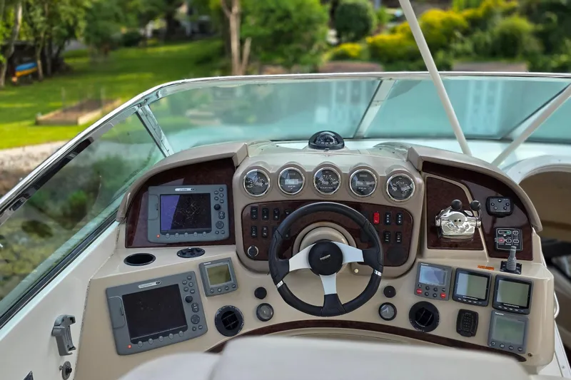 Mardi Gras Yacht Photos Pics Helm of 2006 Carver 56 Voyager yacht with navigation instruments and steering wheel.