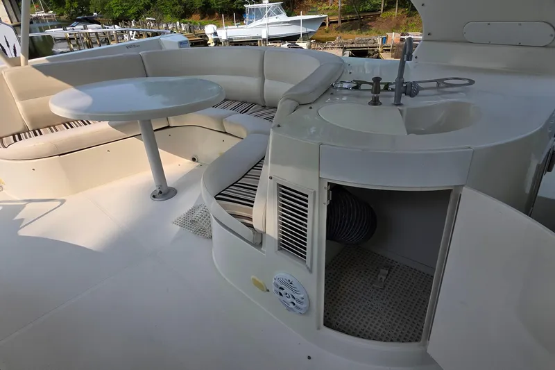 Mardi Gras Yacht Photos Pics 2006 Carver 56 Voyager yacht interior with seating, table, and sink area.