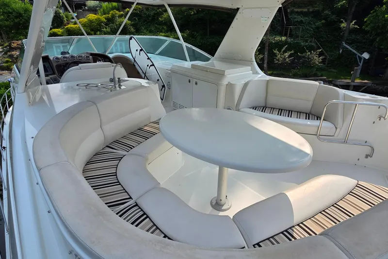 Mardi Gras Yacht Photos Pics 2006 Carver 56 Voyager yacht interior with white seating and round table.