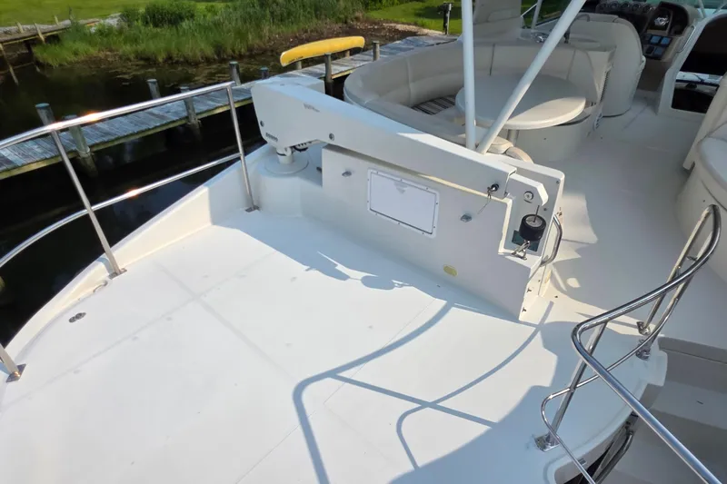 Mardi Gras Yacht Photos Pics 2006 Carver 56 Voyager yacht deck with seating and railing, dockside view.