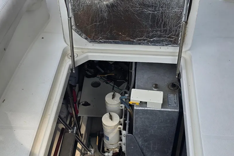 Mardi Gras Yacht Photos Pics Engine compartment of a 2006 Carver 56 Voyager yacht, showcasing mechanical components.