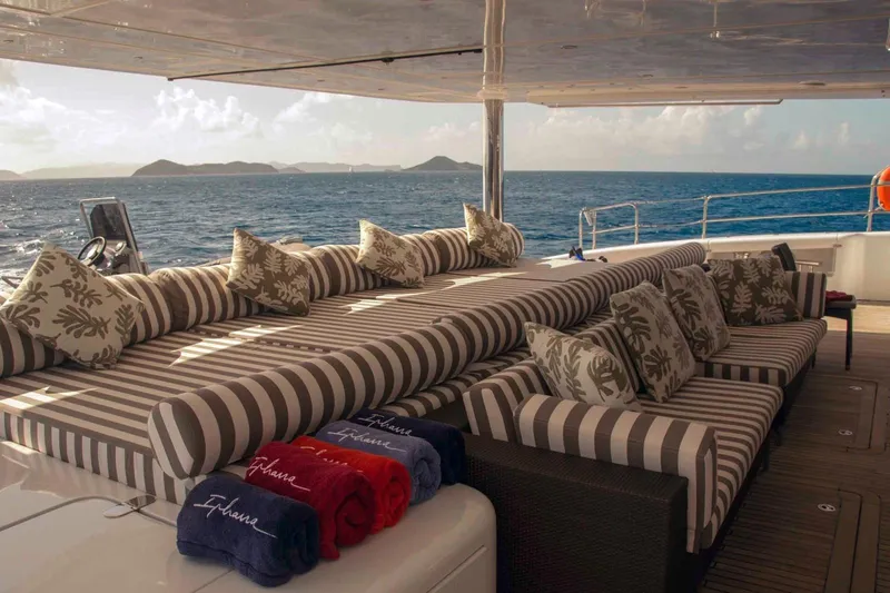 Ipharra Yacht Photos Pics Luxurious Sunreef 31m yacht deck with striped seating, ocean view, and plush cushions, 2009 model.