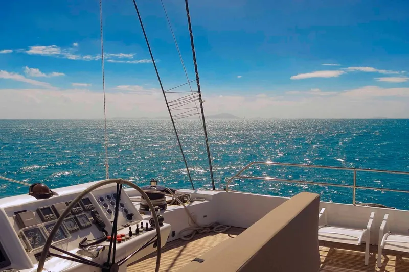 Ipharra Yacht Photos Pics Sunreef 31m yacht deck view, 2009 model, overlooking the ocean under a clear blue sky.