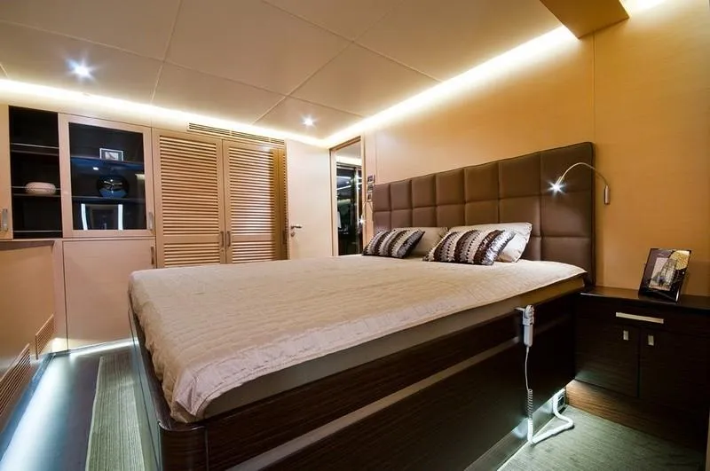 Ipharra Yacht Photos Pics Luxurious bedroom interior on 2009 Sunreef 31m yacht, featuring modern design and ambient lighting.