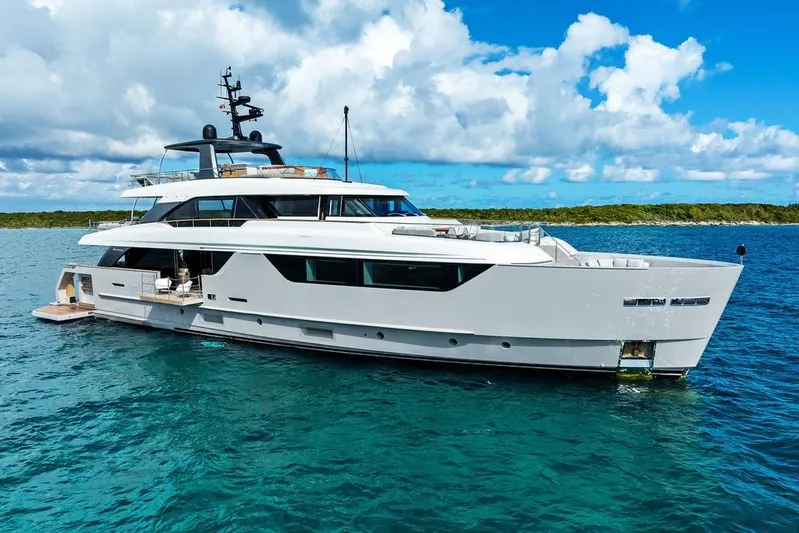 The Wolf Yacht Photos Pics Luxury 2023 Sanlorenzo SD118 yacht on clear blue water under a partly cloudy sky.