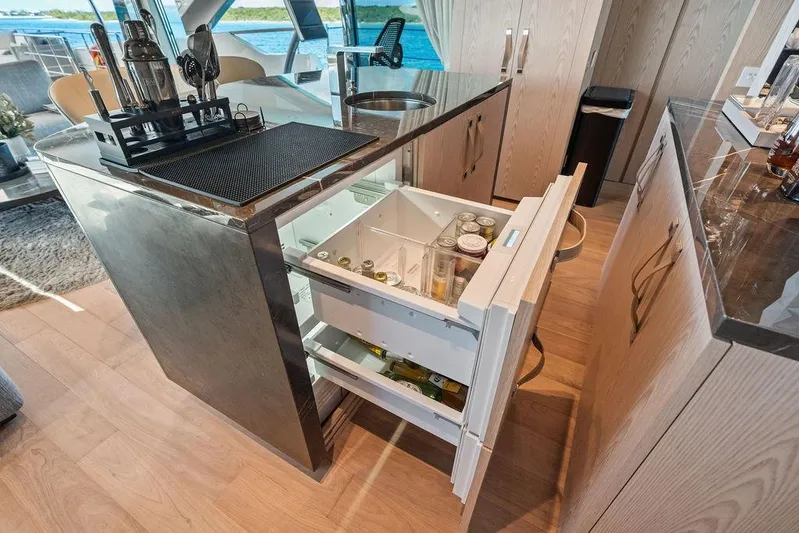 The Wolf Yacht Photos Pics Luxurious 2023 Sanlorenzo SD118 yacht interior with modern bar and beverage storage.