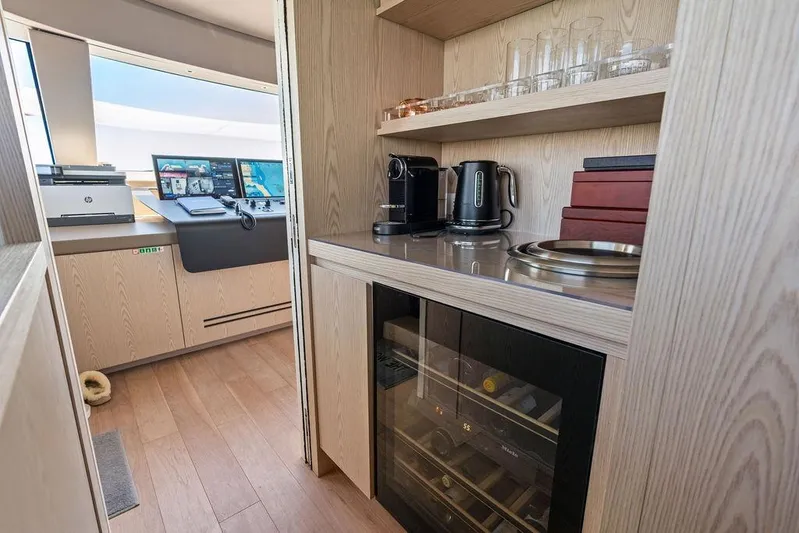 The Wolf Yacht Photos Pics Modern kitchenette on 2023 Sanlorenzo SD118 yacht with appliances and wine cooler.