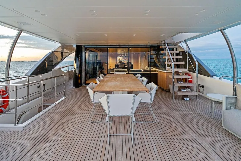 The Wolf Yacht Photos Pics Luxurious 2023 Sanlorenzo SD118 yacht deck with elegant dining area and ocean view.