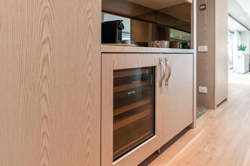 The Wolf Yacht Photos Pics Interior of 2023 Sanlorenzo SD118 yacht with wooden cabinets and wine cooler.