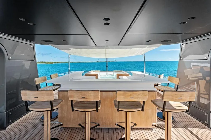 The Wolf Yacht Photos Pics Luxurious 2023 Sanlorenzo SD118 yacht bar with ocean view and wooden seating.