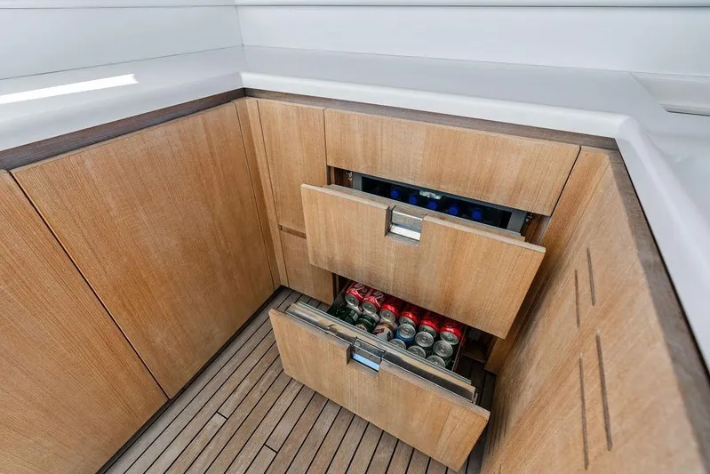 The Wolf Yacht Photos Pics Luxury yacht Sanlorenzo SD118 2023 with sleek wooden cabinetry and beverage storage drawers.