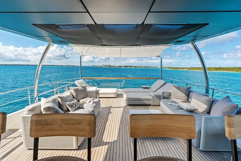 The Wolf Yacht Photos Pics Luxurious 2023 Sanlorenzo SD118 yacht deck with elegant seating, overlooking serene ocean waters.