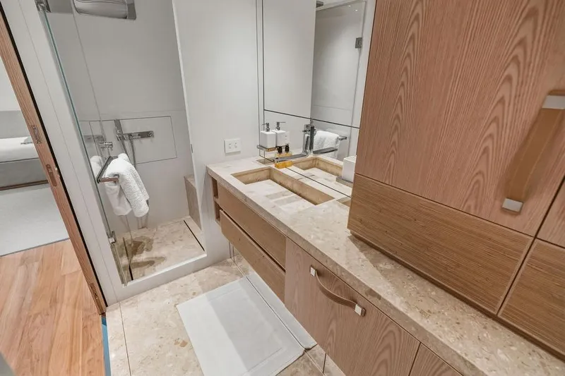 The Wolf Yacht Photos Pics Luxurious bathroom in 2023 Sanlorenzo SD118 yacht with modern fixtures and elegant wood cabinetry.