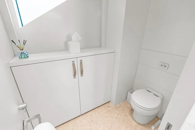 The Wolf Yacht Photos Pics Modern bathroom on 2023 Sanlorenzo SD118 yacht, featuring sleek white cabinetry and toilet.