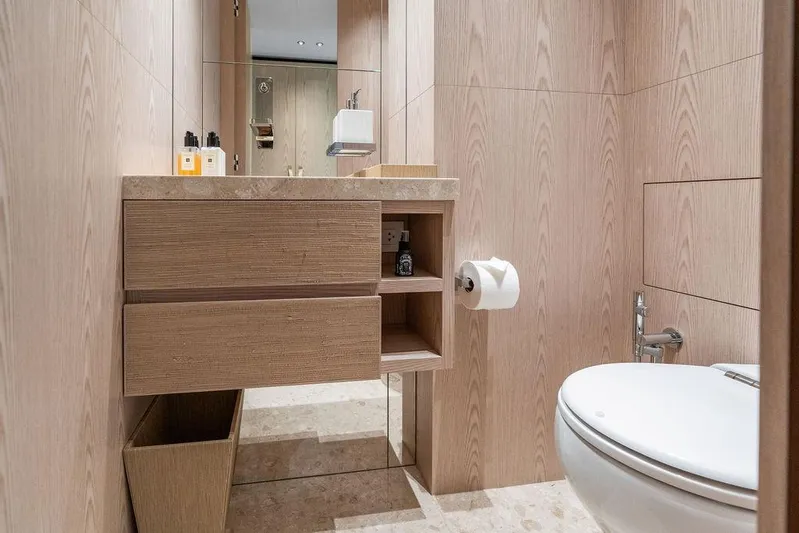 The Wolf Yacht Photos Pics Luxurious bathroom in 2023 Sanlorenzo SD118 yacht with modern wood paneling and sleek fixtures.