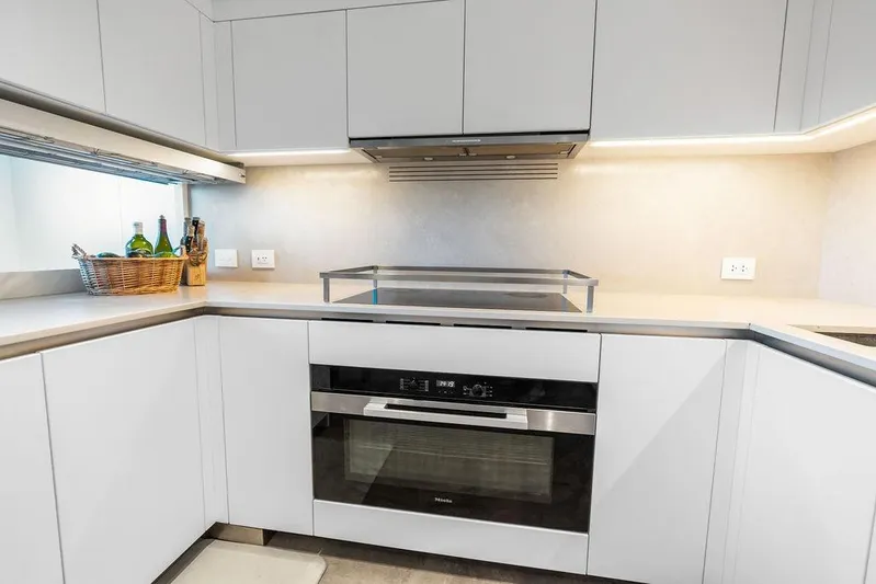 The Wolf Yacht Photos Pics Modern kitchen in 2023 Sanlorenzo SD118 yacht with sleek white cabinetry and built-in oven.