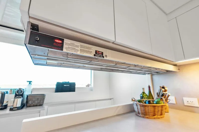 The Wolf Yacht Photos Pics Modern kitchen on Sanlorenzo SD118 yacht, featuring sleek cabinetry and countertop with a wicker basket.