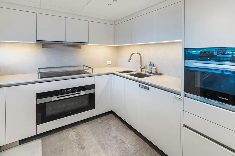 The Wolf Yacht Photos Pics Modern kitchen in 2023 Sanlorenzo SD118 yacht, featuring sleek cabinetry and high-end appliances.