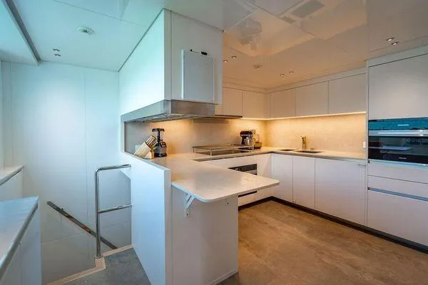 The Wolf Yacht Photos Pics Modern kitchen interior on 2023 Sanlorenzo SD118 yacht, featuring sleek white cabinetry and appliances.