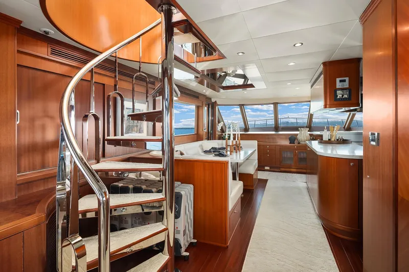 Estancia Yacht Photos Pics Luxurious interior of 2010 Ocean Alexander 80 Motoryacht with spiral staircase and elegant wood finishes.