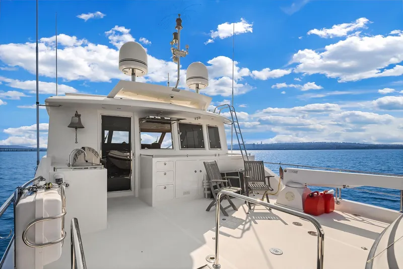 Estancia Yacht Photos Pics Luxurious 2010 Ocean Alexander 80 Motoryacht deck with seating, under a vibrant blue sky.