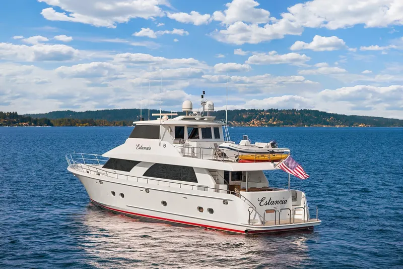 Estancia Yacht Photos Pics Ocean Alexander 80 Motoryacht 2010 cruising on a serene blue lake under a cloudy sky.