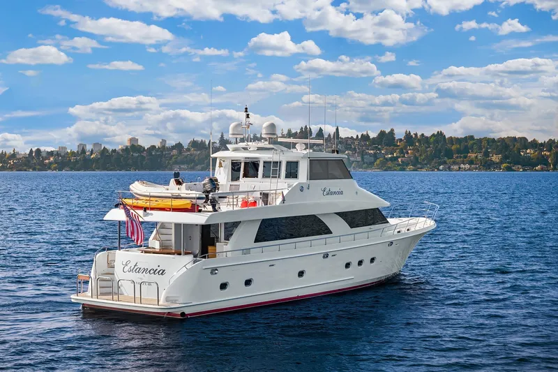 Estancia Yacht Photos Pics Ocean Alexander 80 Motoryacht 2010 cruising on a scenic lake under a blue sky.