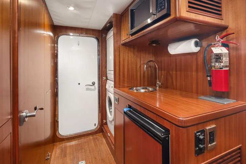 Estancia Yacht Photos Pics Laundry area in 2010 Ocean Alexander 80 Motoryacht with washer, dryer, and kitchenette.