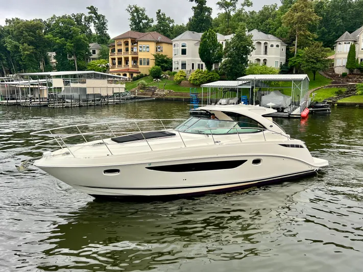  Yacht Photos Pics 2014 Sea Ray 410 Sundancer yacht on a scenic lake with luxury homes.