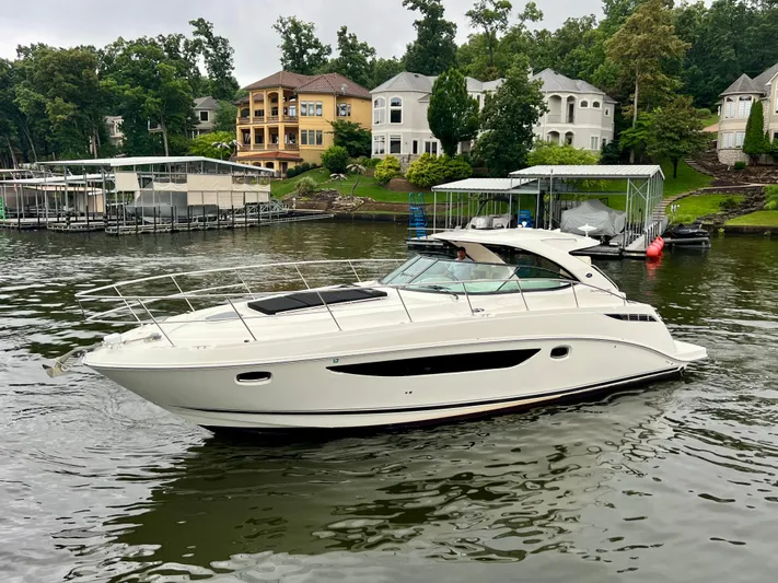  Yacht Photos Pics 2014 Sea Ray 410 Sundancer yacht cruising on a scenic lake near luxury homes.