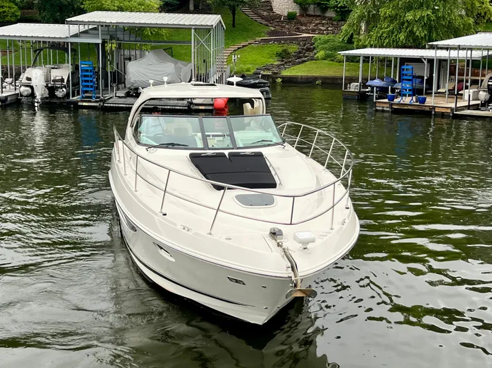  Yacht Photos Pics 2014 Sea Ray 410 Sundancer yacht docked on a serene lake.