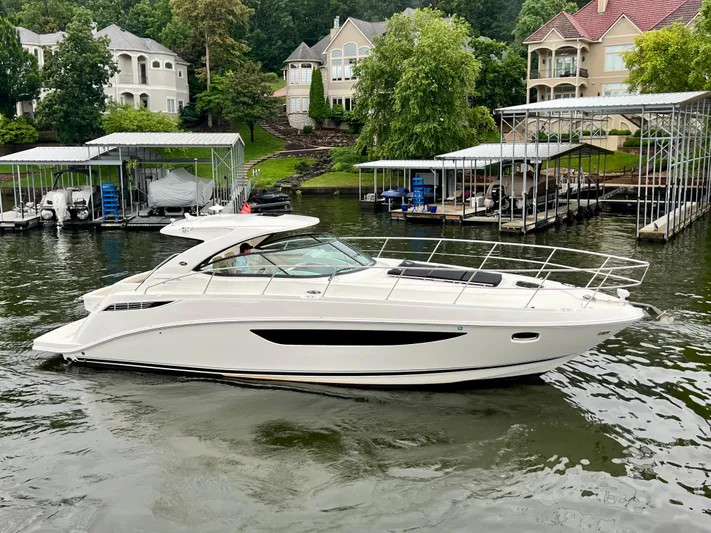  Yacht Photos Pics 2014 Sea Ray 410 Sundancer yacht docked near waterfront homes and boat slips.